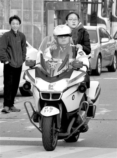 7日，首爾，警察將一名考生送抵考場。新華社發(fā)