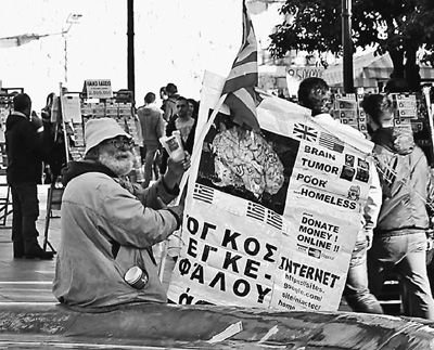 自債務危機爆發(fā)以來，希臘承諾實施以減薪、增稅、裁員和私有化為主要內容的緊縮和改革政策。一系列的緊縮措施使民眾生活受到嚴重影響，約1/4的家庭陷入貧困。圖為今年1月希臘大選期間，在雅典市中心國會大廈前廣場乞討的老人。