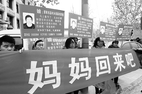 張慧媛老人的子女們舉著尋找母親的牌子和橫幅，在冷風中呼喊著“媽媽，您快回來吧”。