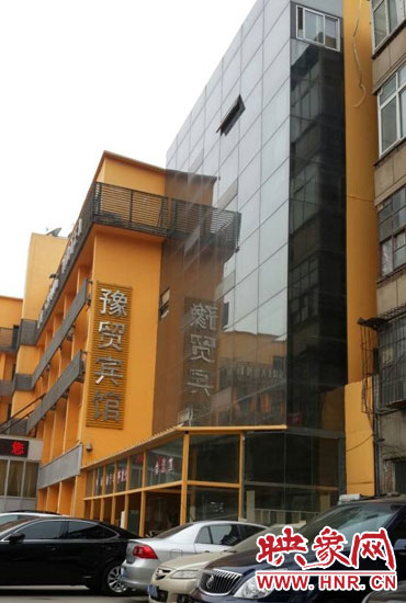 該酒店為加蓋樓層統(tǒng)一安裝上黑色玻璃，從前面看不出加蓋的痕跡