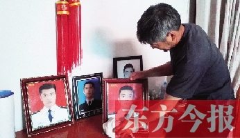 沉浸在悲痛之中的魯有海，擦拭著孩子的遺照