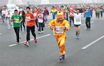 長安街，一名打扮成孫悟空的參賽者在北馬隊伍里飛奔。 本版攝影/新京報記者 吳江 李飛 王嘉寧 吳江